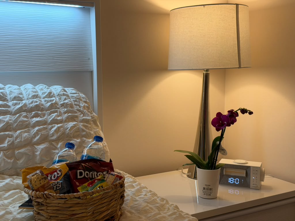 Welcome basket with bottled water and snacks on the queen bed